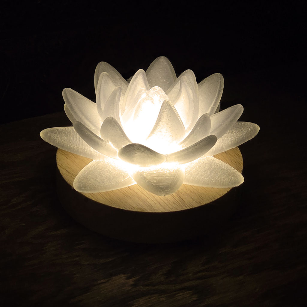 Lotus lamp glowing warmly in the dark